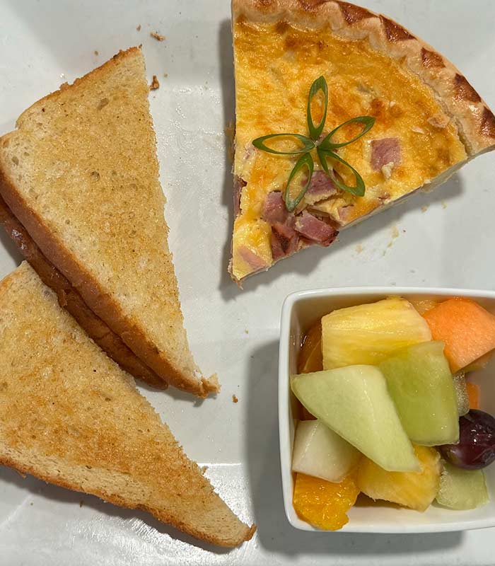 Omar's Hi-Way Chef in Tuscan AZ is serving quiche with fruit and toast.